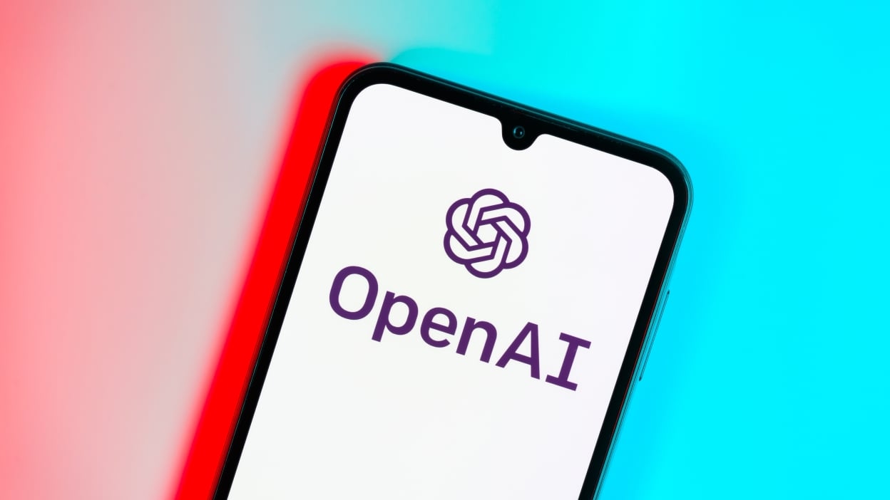 Smartphone on surface showing OpenAI logo. OpenAI is a nonprofit organization for artificial intelligence research.