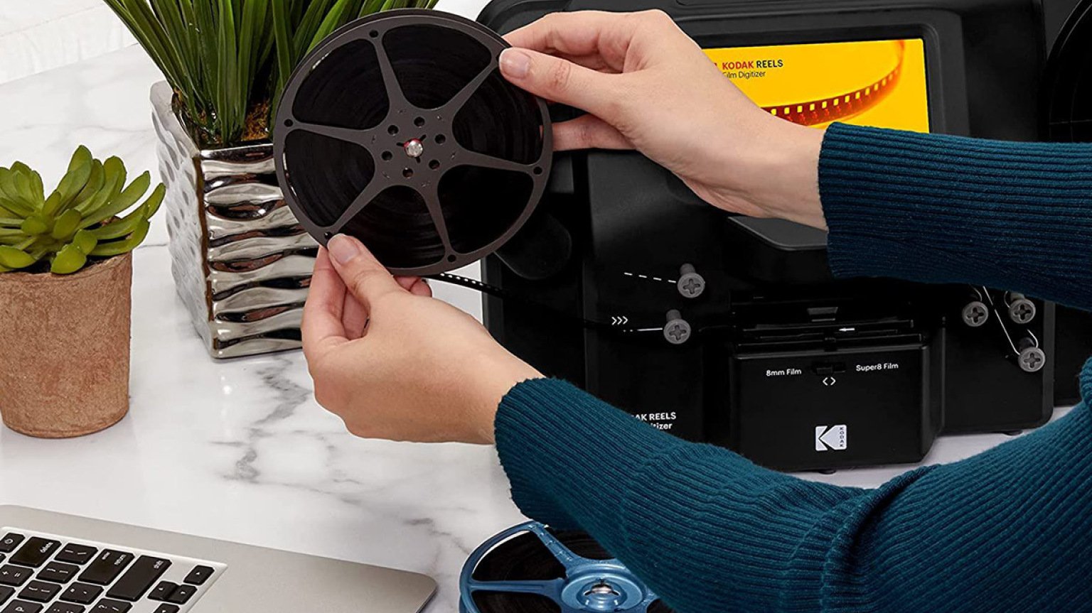 person using Kodak Reels film digitizer