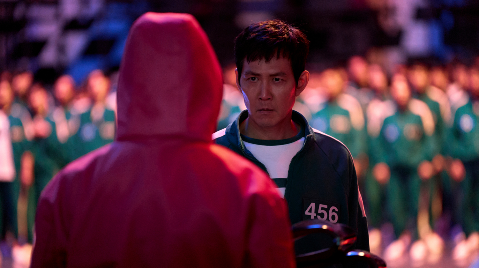 Lee Jung-jae as Seong Gi-hun in Squid Game Season 2, facing off with a game overseer.