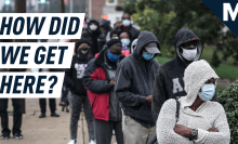 a line of people waiting to vote