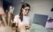 Woman working on a laptop.