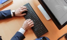 Person typing on a computer.