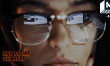 woman wearing glasses with a computer screen in their reflection