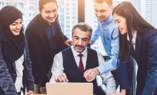 Group of multiethnic business people training by executive senior boss in modern office with laptop computer.