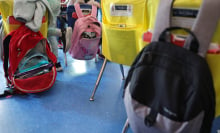 backpacks hanging off desk chairs in a classroom