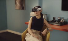 Photo of a woman using Apple's Vision Pro AR headset. 