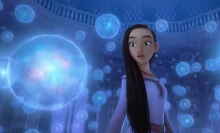 A screenshot from Disney's "Wish" trailer, showing Asha surrounded by bubbles of wishes.