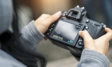 Close up selective focus of Model checking her photos on a camera screen