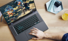 a top-down view of a man playing "the witcher 3" on a Acer Chromebook 516 GE at a wooden desk