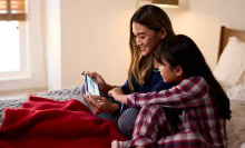 A young woman and child play the nintendo switch together