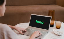 woman watching Hulu on laptop