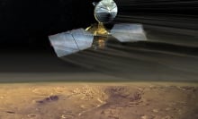 An artist's conception of the Mars Reconnaissance Orbiter swooping over the Martian desert.