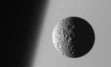 Mimas moon orbiting Saturn