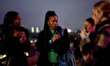 Four young woman at a rooftop party.