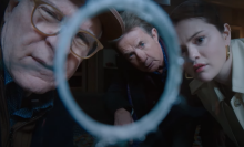 Charles (Steve Martin), Oliver (Martin Short), and Mabel (Selena Gomez) peer through a bullet hole in "Only Murders in the Building"