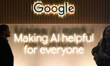 People in front of the Google logo on a wall above a slogan about making AI helpful for everyone