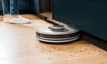 the shark AI ultra robot vacuum picks up colorful sprinkles on a hardwood floor