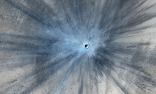 NASA's Mars Reconnaissance Orbiter captured an image of a fresh impact crater on Mars in 2013.