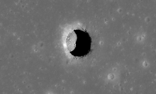 A pit, leading to a cave, in the Mare Tranquillitatis region of the moon.