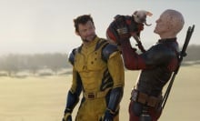 Wolverine watches on in disgust as Deadpool lifts up Dogpool.