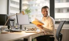 smiling man at his office desk