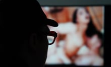 A man is looking at a porn internet site on a screen