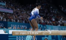 Simone Biles hops down from the balance beam. 