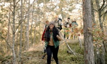 a group of people hiking in nature while all wearing packs and fall clothing