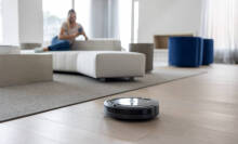 person using a robot vacuum