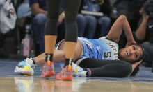  Angel Reese #5 of the Chicago Sky lays on the court 