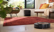 An iRobot Roomba on a living room floor.