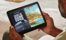 man looking at an Amazon Fire tablet 