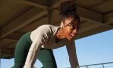 a female runner in the starting spring position wears the jbl endurance peak 3 headphones