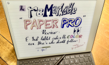 A Remarkable Paper Pro e-ink screen has a 'Remarkable Paper Pro' review written on it. 