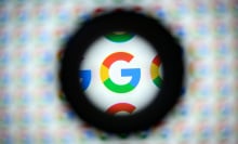 A magnified Google logo on a blurry background.