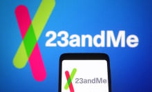 23andme logo on a phone in front of a blue background with the same logo