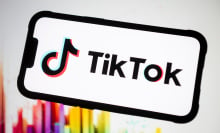 tiktok logo on a phone screen with colorful background