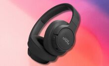 black jbl tune 770nc headphones on a light pink and purple gradient background