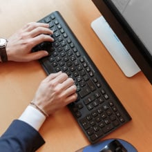 Person typing on a computer.