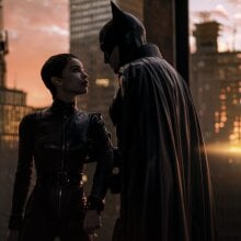 Zoë Kravitz and Robert Pattinson stand on a rooftop in The Batman