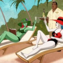 Poison Ivy and Harley Quinn relax on a beach. 