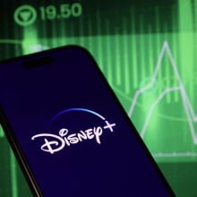 Disney+ logo over stocks background