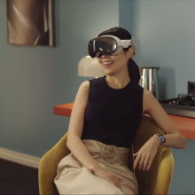 Photo of a woman using Apple's Vision Pro AR headset. 