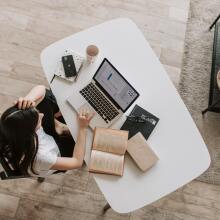 woman at a desk with papers and laptop