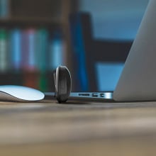 The TOKK CAM standing next to a laptop on a desk.