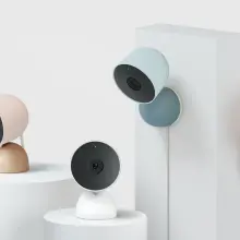 four google nest cameras in various colors