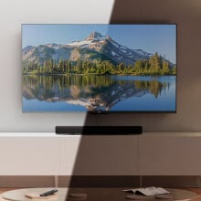 Amazon QLED TV on TV stand with light hitting half of the TV