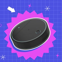 Robot vacuum inside purple shape on purple grid backdrop