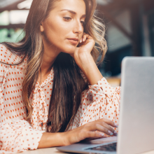 woman browsing the web on laptop in public