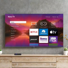 Hanging TV with streaming apps and Roku smart TV platform on screen with furniture and plants in peripherals